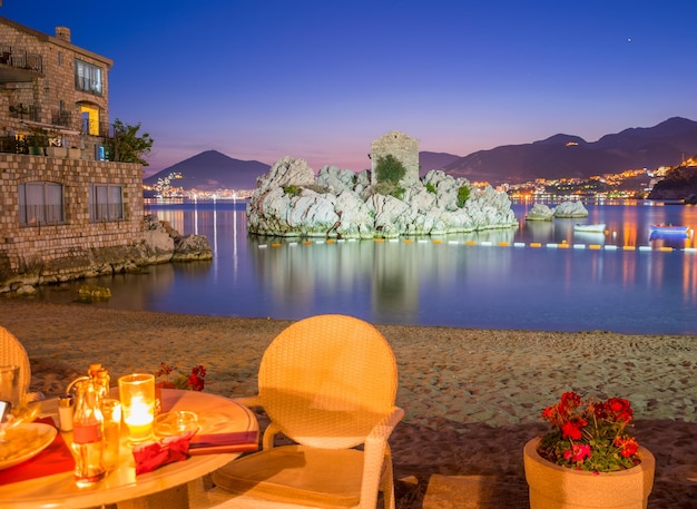 MONTENEGRO PRZNO the restaurant staff prepared their tables near the sea for dinner during sunset