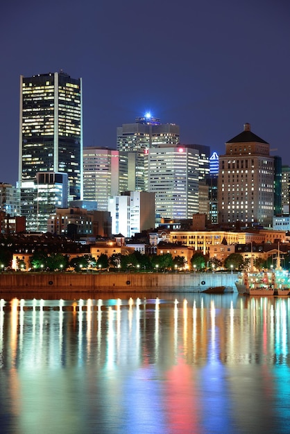 Montreal over river at dusk with city lights and urban buildings