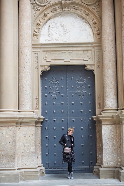 Montserrat Spain April 5 2019 Young wonan poses in front of the Santa Maria de Montserrat Abbey Catalonia Spain