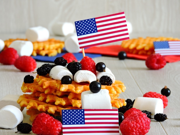 The mood of July 4. Sweets for a party on July 4. Marshmallow and berries. Decoration in the style of  Independence Day.