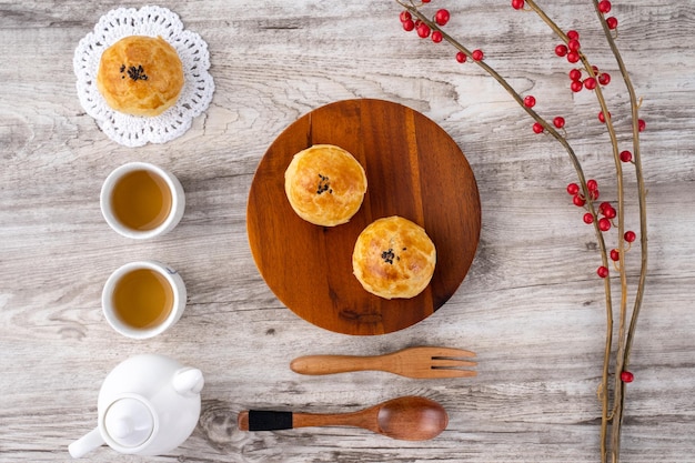 Moon cake yolk pastry mooncake for MidAutumn Festival holiday top view design concept on bright wooden table with copy space flat lay overhead shot