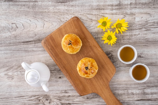 Moon cake yolk pastry mooncake for MidAutumn Festival holiday top view design concept on bright wooden table with copy space flat lay overhead shot