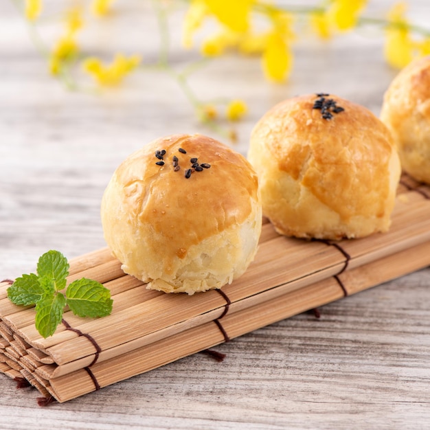 Moon cake yolk pastry mooncake for MidAutumn Festival holiday top view design concept on bright wooden table with copy space