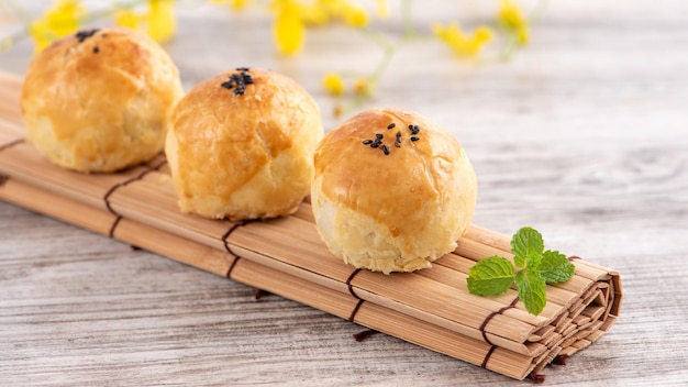 Moon cake yolk pastry mooncake for MidAutumn Festival holiday top view design concept on bright wooden table with copy space