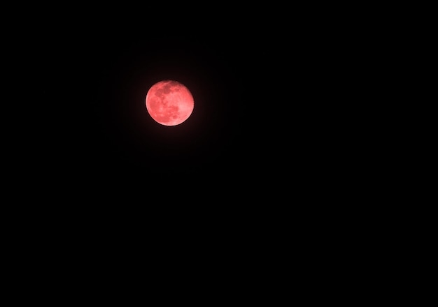 Moon with color on the dark sky at night and isolated black background.