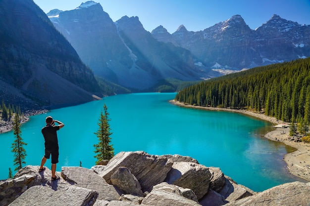 Moraine Lake Rockpile Trail in summer sunny day morning, Tourists taking pictures on the beautiful scenery.