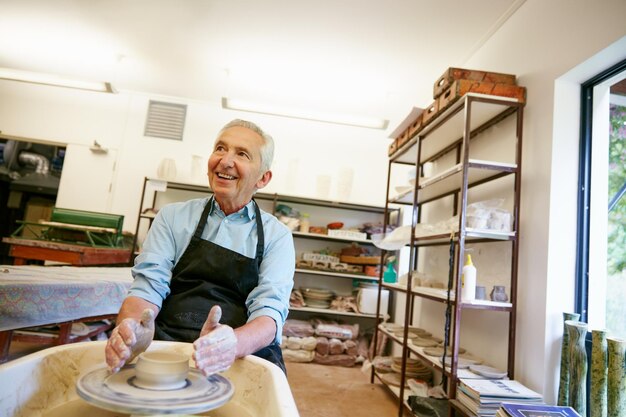 Do more things that make you happy Shot of a senior man making a ceramic pot in a workshop