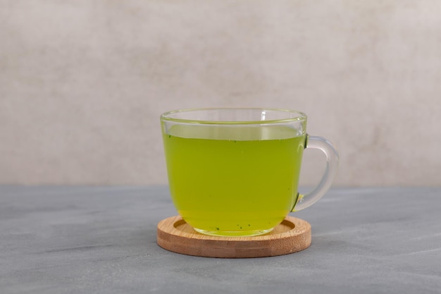 Moringa tea in clear cup Herbal drink of green moringa leaves Alternative medicine