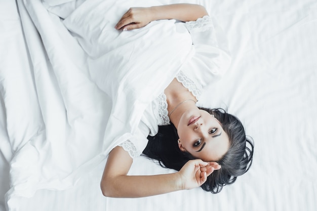 Morning of a beautiful girl in bed. Top view