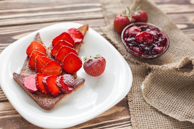 Morning breakfast. Toasts with strawberry and jam. Bread and confiture.