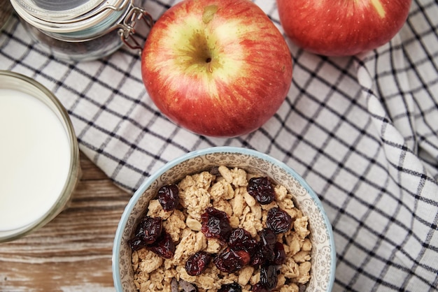 Morning breakfast with granola on wooden background top view