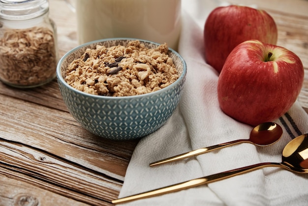 Morning breakfast with granola on wooden background