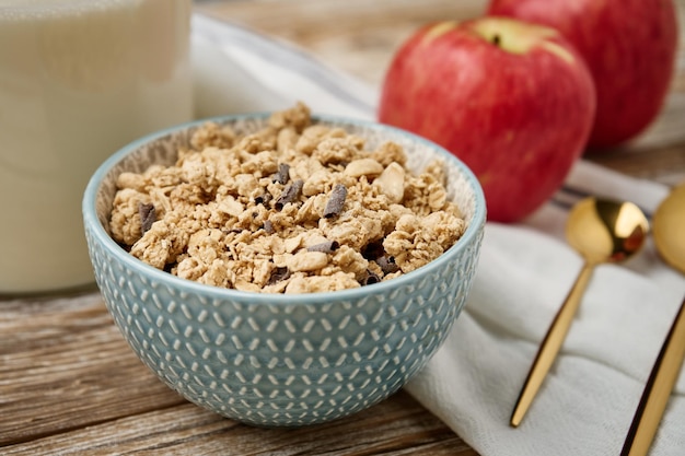 Morning breakfast with granola on wooden background