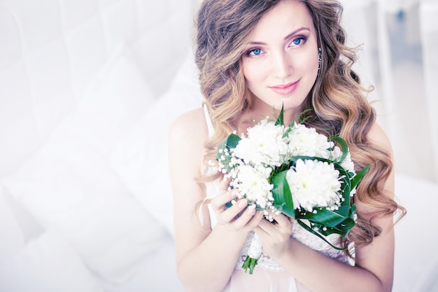 Morning of the bride in a beautiful bright Studio with flowers .