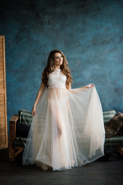 Morning of the bride.girl posing in white lace underwear.