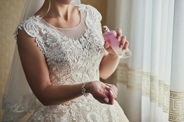 Morning of the bride when she wears a beautiful dress woman getting ready before wedding ceremony