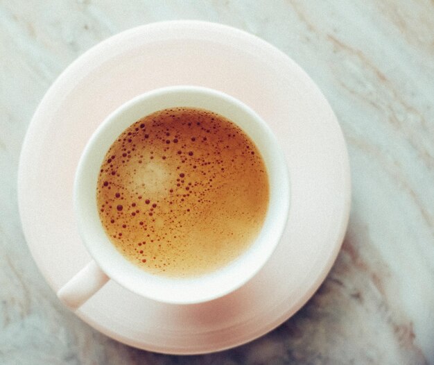 Morning coffee cup with milk on marble stone flat lay hot drink on table flatlay top view food photography and recipe inspiration for cooking blog or cookbook