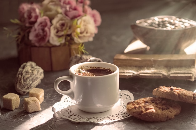 Morning coffee with biscuits and pieces of cane sugar in the sun. 