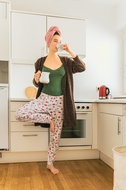 Morning coffee in yoga pose at home of teenage girl