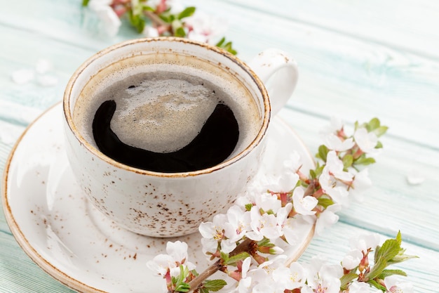 Morning espresso coffee cup and cherry blossom