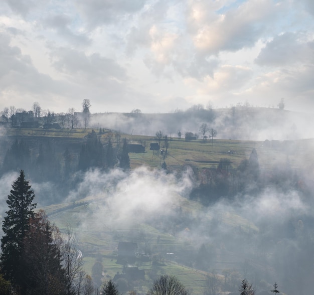 Morning foggy clouds in autumn mountain countryside Ukraine Carpathian Mountains Transcarpathia