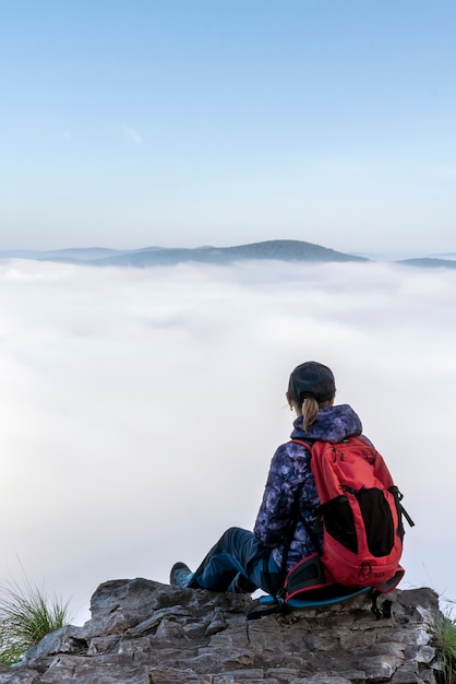 Morning in the mountains a woman a girl a tourist the gray haze stretches over