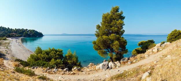 Morning sandy Kaviou beach. Summer top view (Nikiti, Sithonia, Halkidiki, Greece). People are unrecognizable. Two shots stitch panorama.