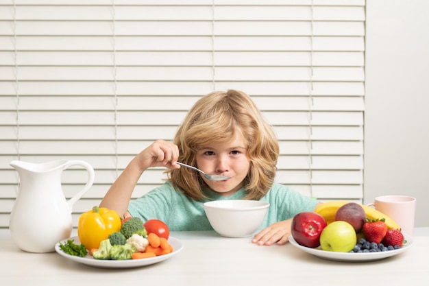 Morning snack with muesli cereal granola portrait of child eat fresh healthy food in kitchen at home