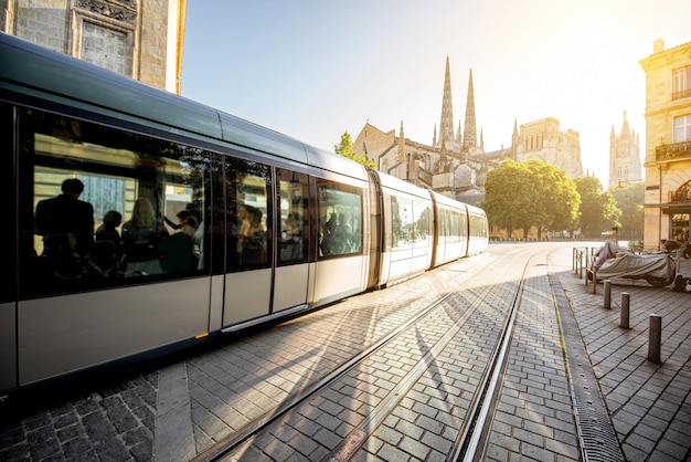 Photo morning street view with tram and saint pierre cathedral in bordeaux city, france