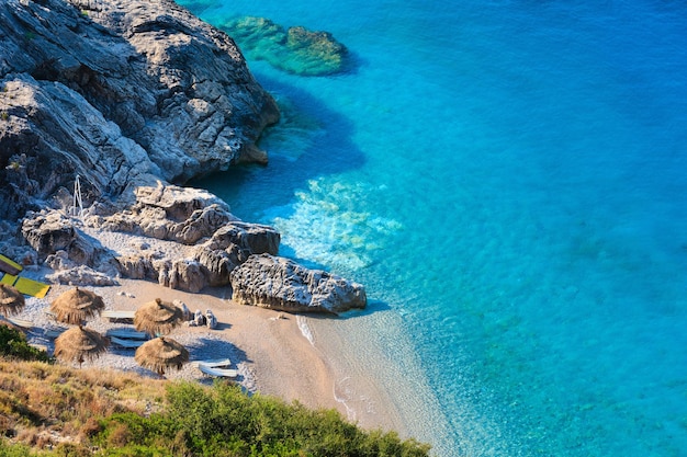 Morning summer Ionian sea coast and beach with transparent aquamarine water Albania