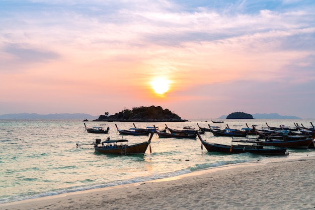 morning sun rise many wooden longtail boats parking on blue sea at sunrise beach peaceful sea view