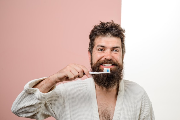 Morning treatments morning routine smiling bearded man brushing teeth tooth brush tooth paste health