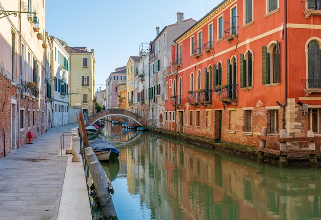 Morning in Venice water channels along residential buildings cityscape