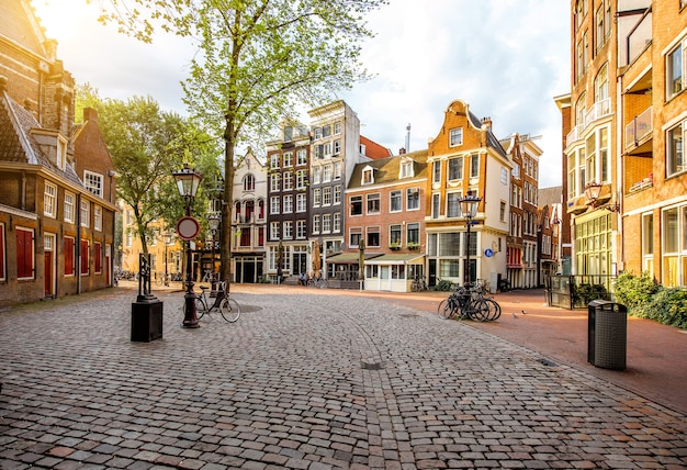 Morning view on the square with beautiful buildings near the Old Church in Amsterdam city