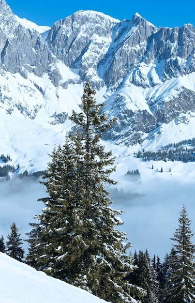 Morning winter mountain landscape with clouds in below valley (Hochkoenig region, Austria)