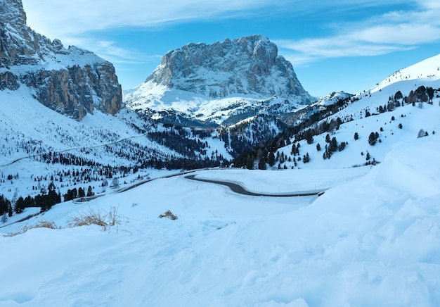 Morning winter rocky mountain landscape with serpentine road . Gardena Pass  in Dolomites of South Tyrol in northeast Italy.