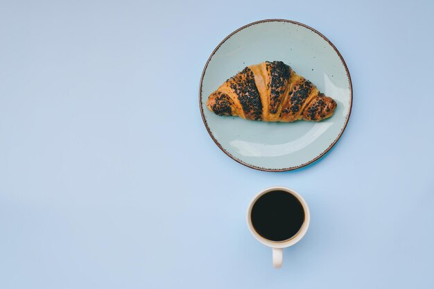 morning with notebook, cups of hot black coffee  on blue background. Top view, copy space, mockup.