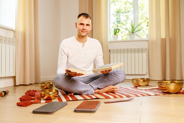 Morning yoga practice with sadhu nails mans foot on the wooden desk with sharp metal nails