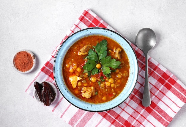 Moroccan harira soup in blue bowl at grey concrete table top harira is moroccan cuisine dish with la