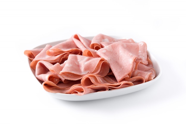 Mortadella slices on white plate isolated on white surface