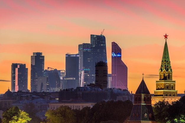 Moscow city business center and towers of Moscow Kremlin at pink sunset