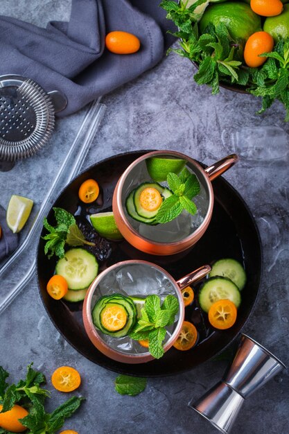 Moscow mule cocktail with lime mint cucumber and kumquat