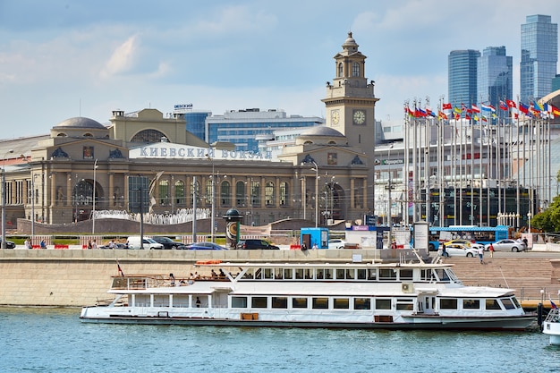 Moscow, Russia - May 29 , 2019: Modern riverboat on the river in the city, near shopping centers and the railway station. The ship is moored in a picturesque modern urban architecture.