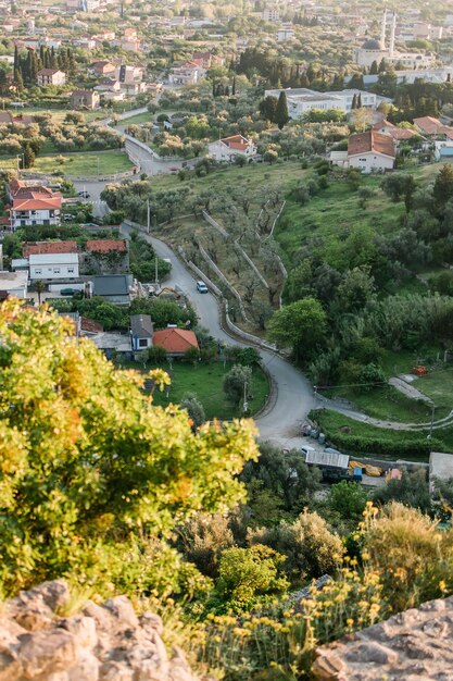 Mosque and panoramic cityscape of town bar in montenegro with road and houses aerial view