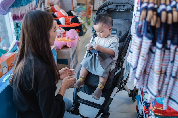 Mother are trying to fit the product on her son before purchase it