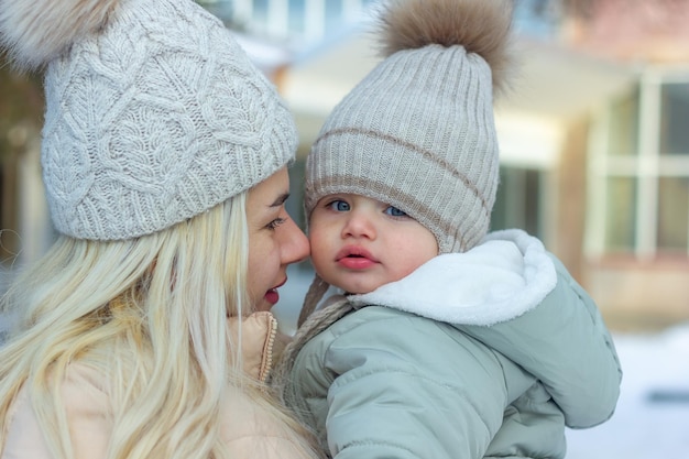 mother and baby boy in winter parent and child in winter park