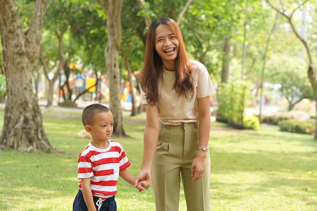 Mother and baby playing in the park happily