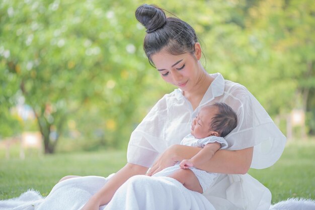 Mother carries and touches her child with tenderness and cherishness