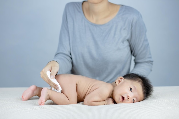 Mother changing a diaper to little baby