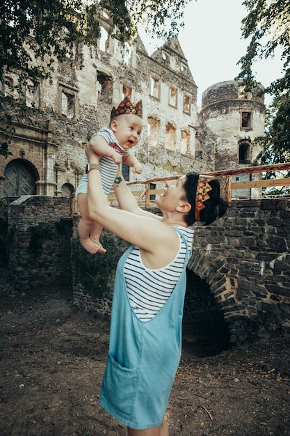 mother and child in crowns on the background of an ancient castle. Prince and Queen